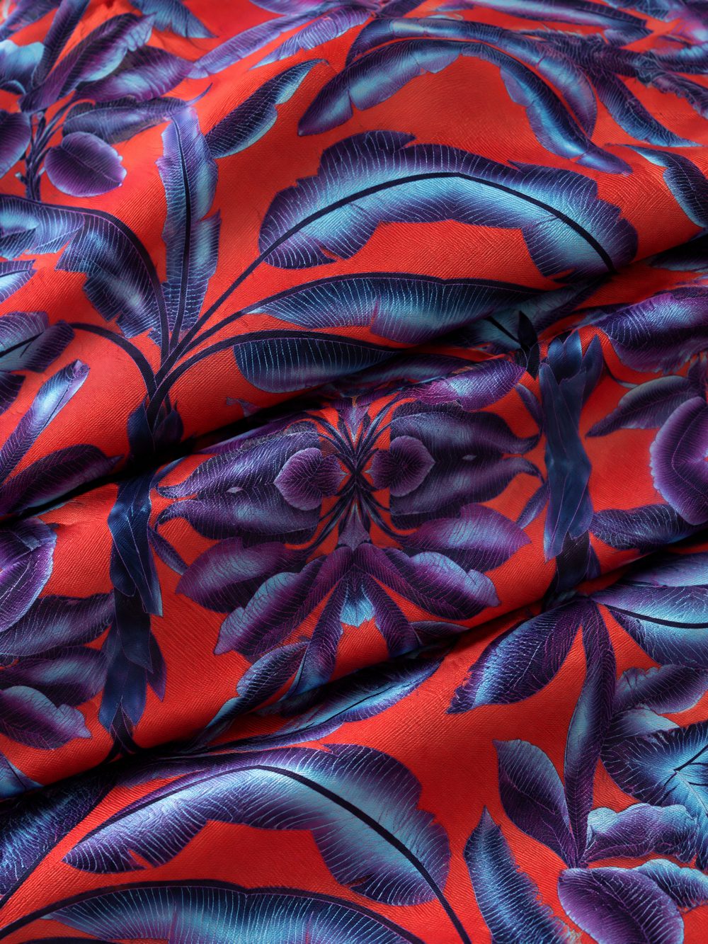 Close-up of Blue Dragons on Vermilion Ground printed on folded fabric