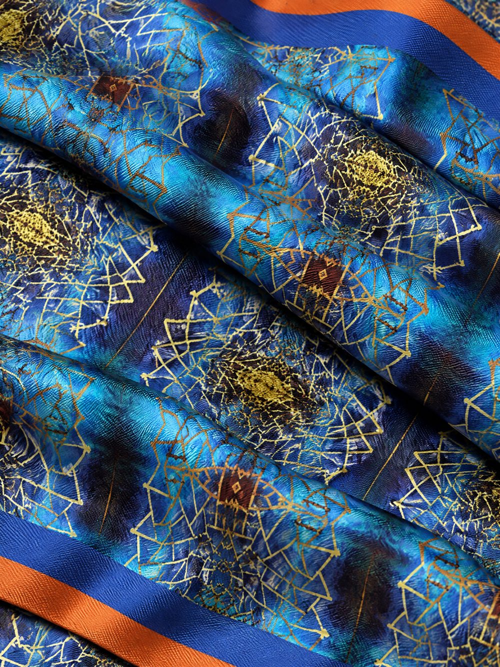 Close-up of Golden Screen Against The Sea printed on folded fabric
