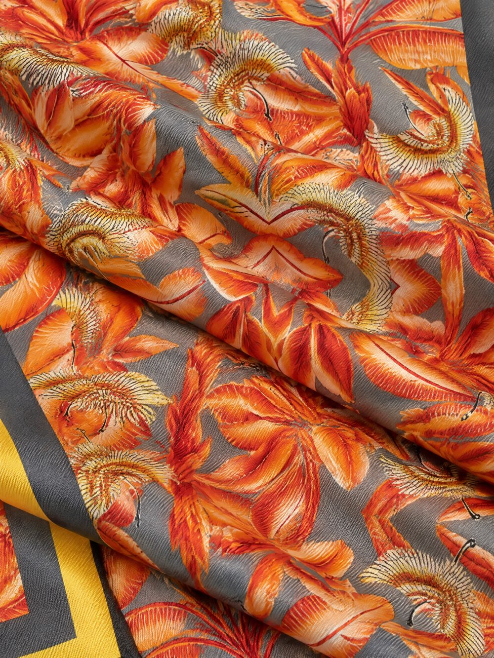 Close-up of Orange Cranes Gray Ground printed on folded fabric