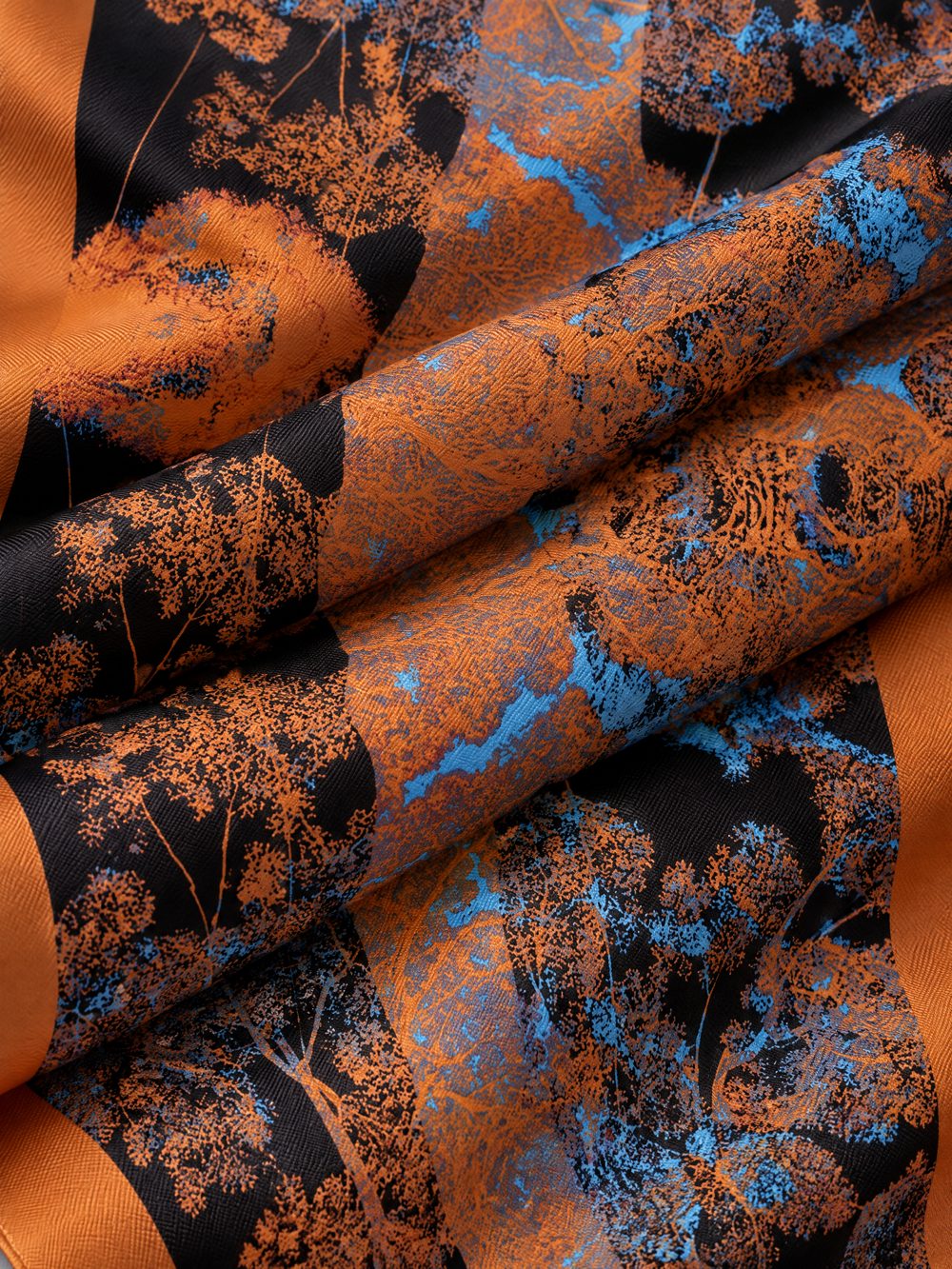 Close-up of The Forest Glows at Night printed on folded fabric