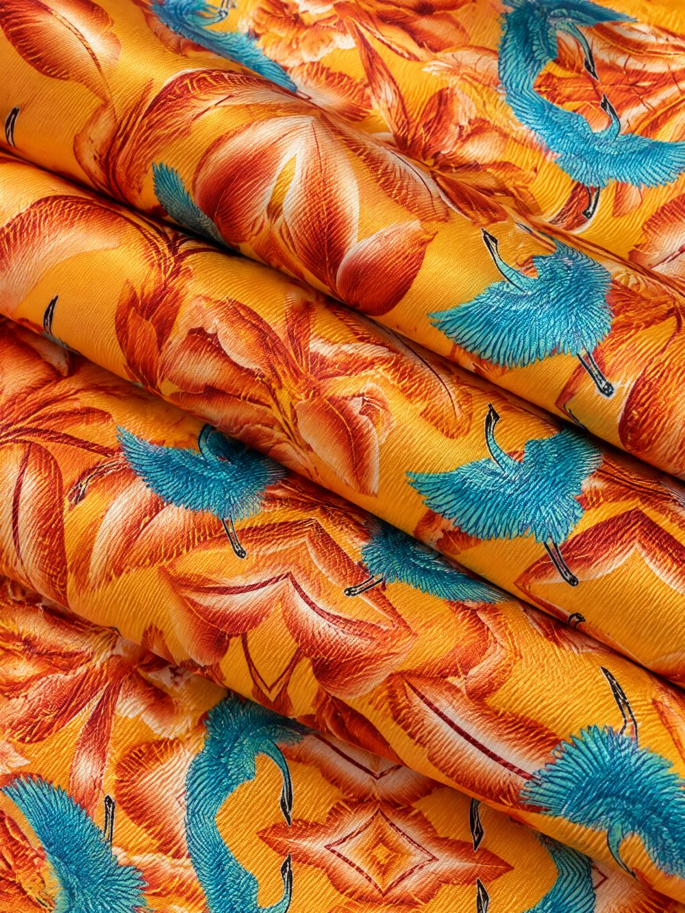 Close-up of Turquoise Cranes and Yellow Sky printed on folded fabric
