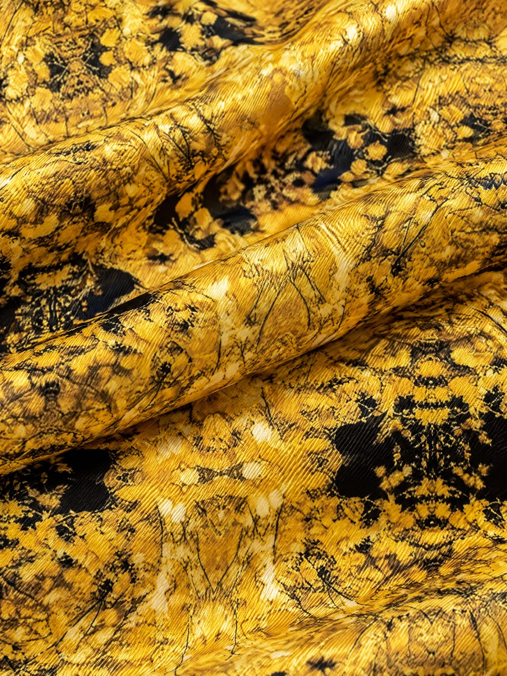 Close-up of Yellow Botanicals in Hanoi printed on folded fabric